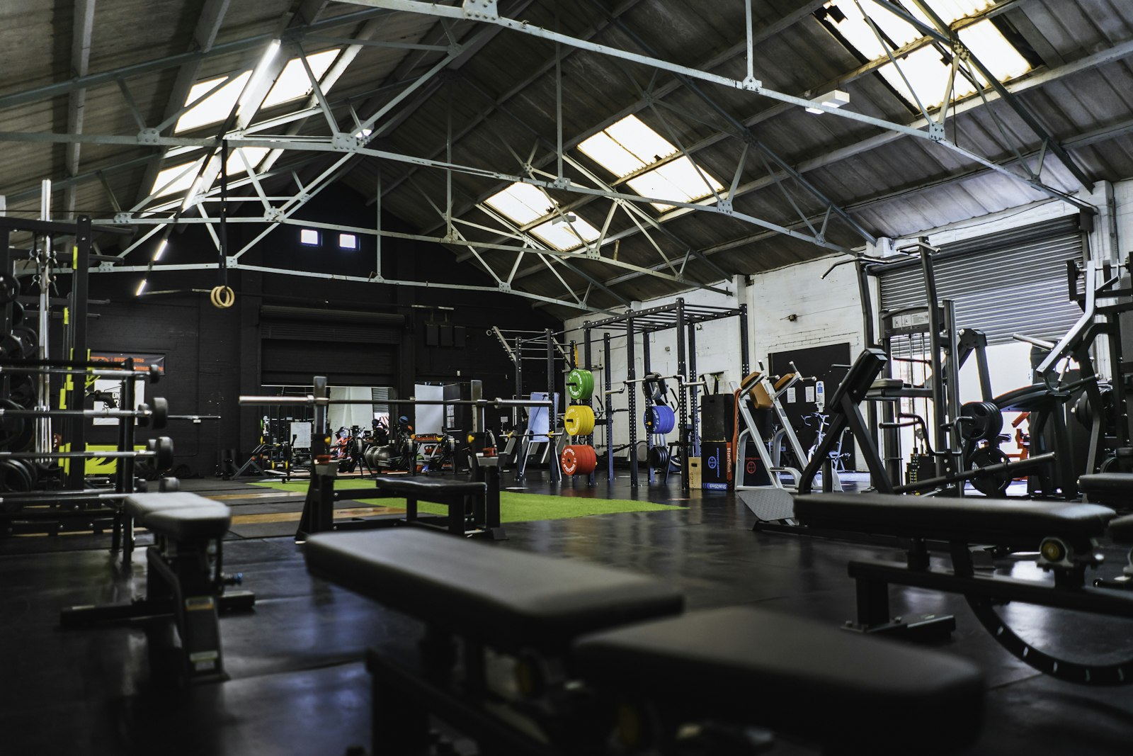 Weightlifting equipment and benches in a spacious gym